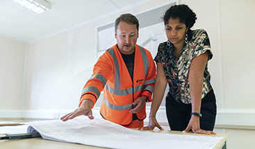 Two people reviewing a plan